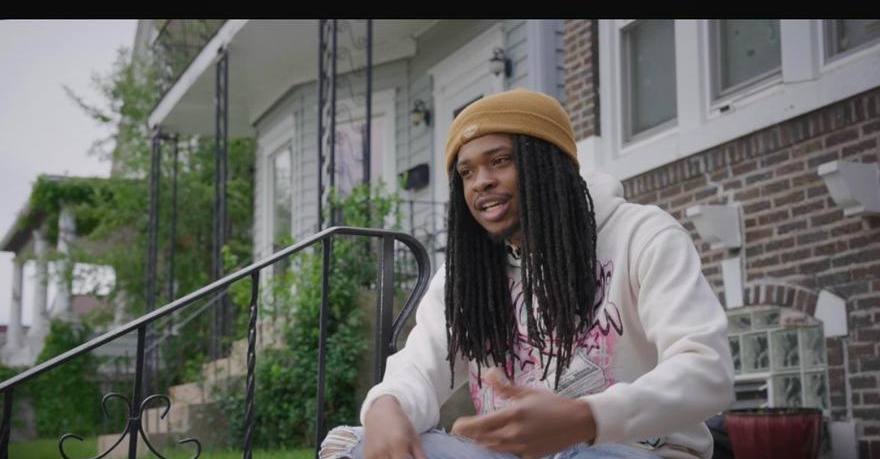 Young man telling his story from his front steps